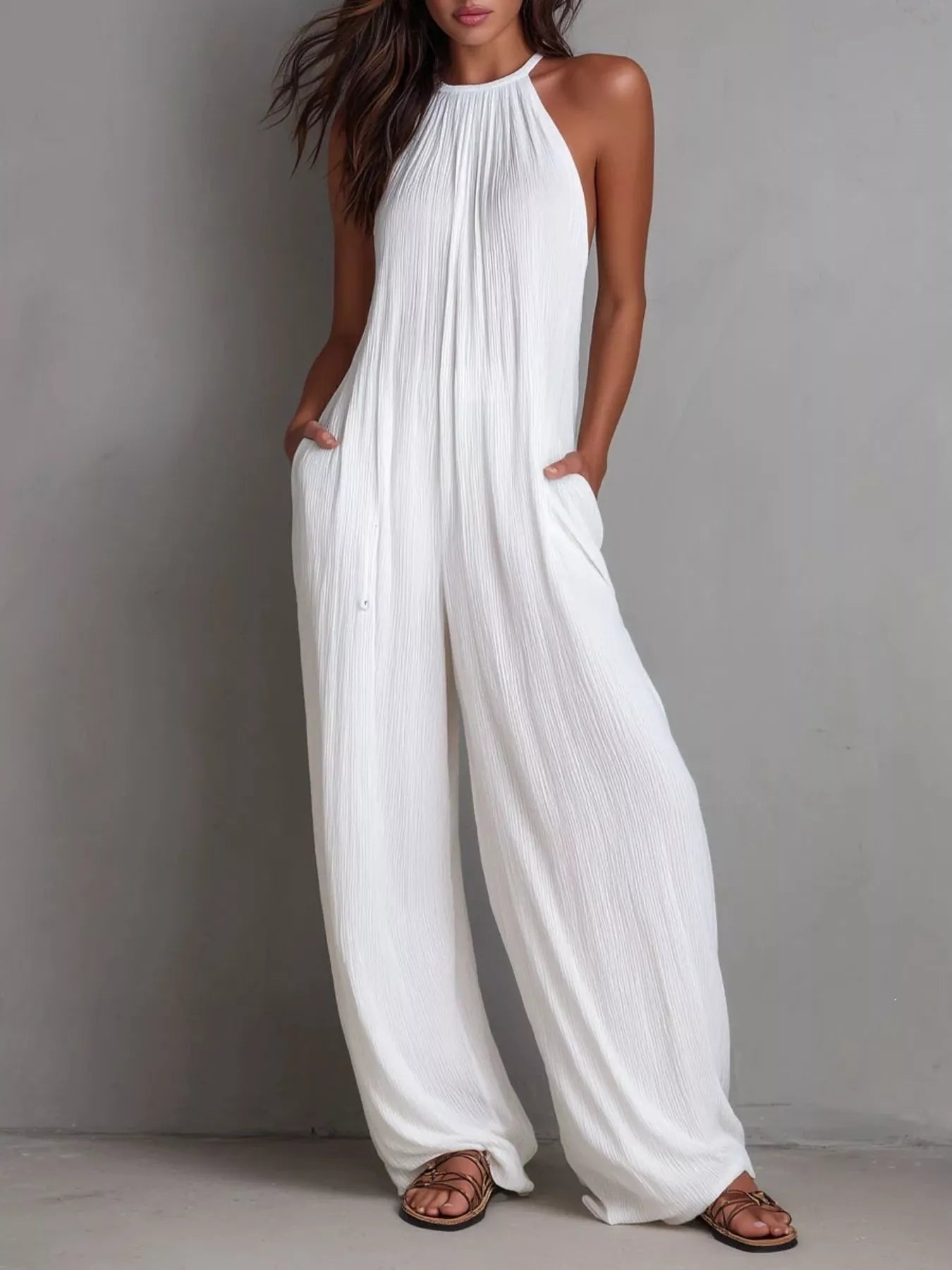 Women's sleeveless wide-leg jumpsuit with pockets and a zipper closure.