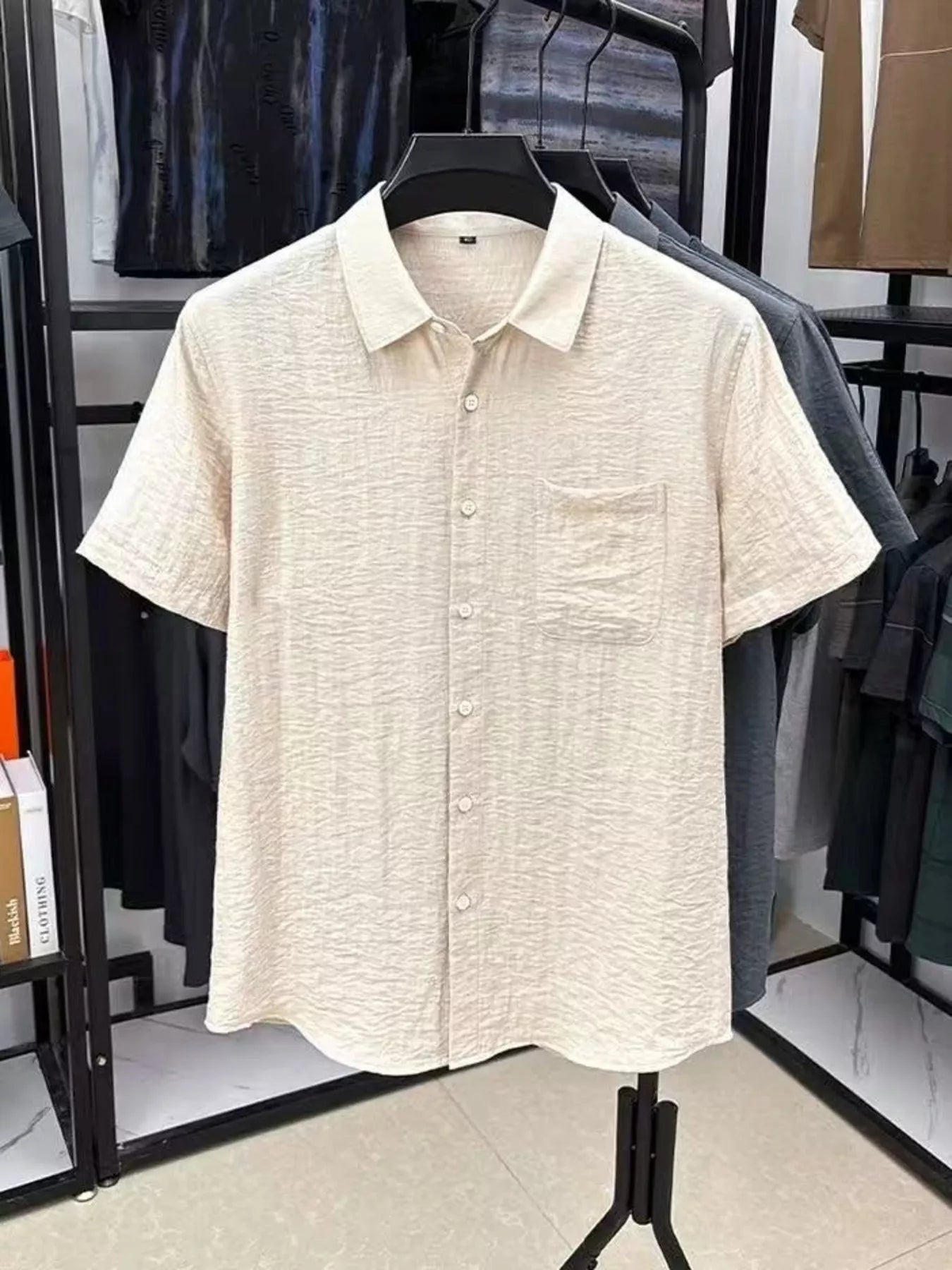 Men's lightweight textured shirt with short sleeves and button detailing.