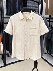 Men's lightweight textured shirt with short sleeves and button detailing.