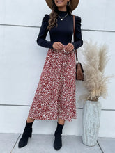 Women's printed midi dress with a mock neckline and puff sleeves.