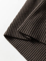 Close up detail of coffee brown ribbed hem on folded sweater vest