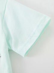 Close-up of the mint blue short sleeve hem with fine stitching on a children's polo shirt