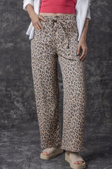 Women's leopard-print wide-leg jeans with a drawstring waist and pockets.