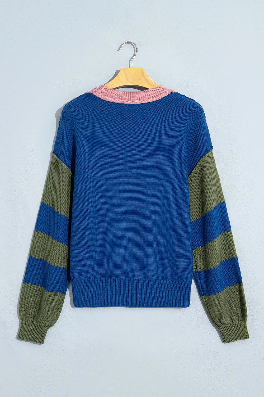 Flat lay back view of the sweater with a blue body and pink collar