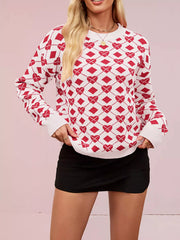 On-model front view of a white knit sweater with red heart argyle pattern, hands at hem