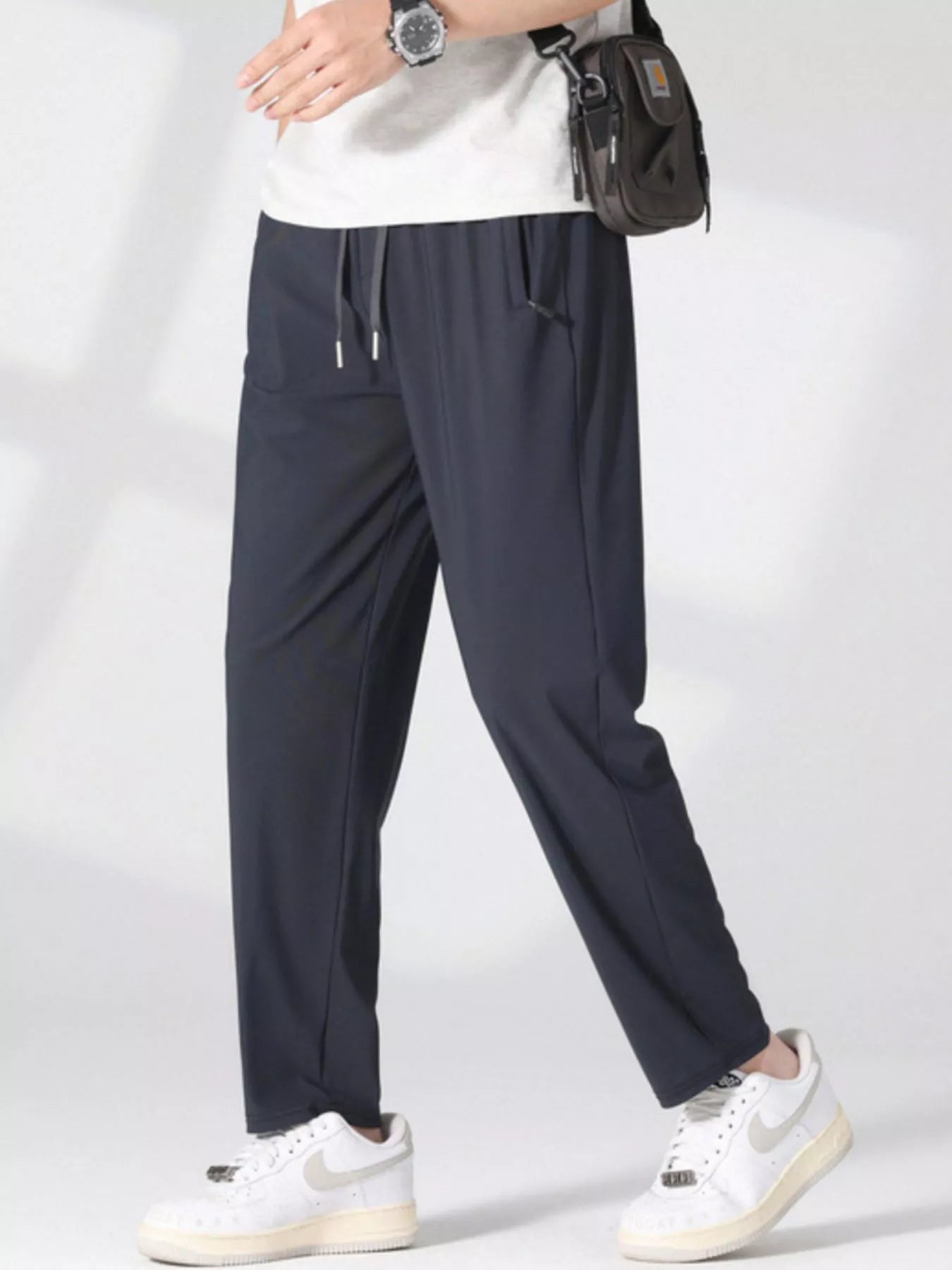 Men's dark gray lightweight casual pants with a drawstring waist and pockets.