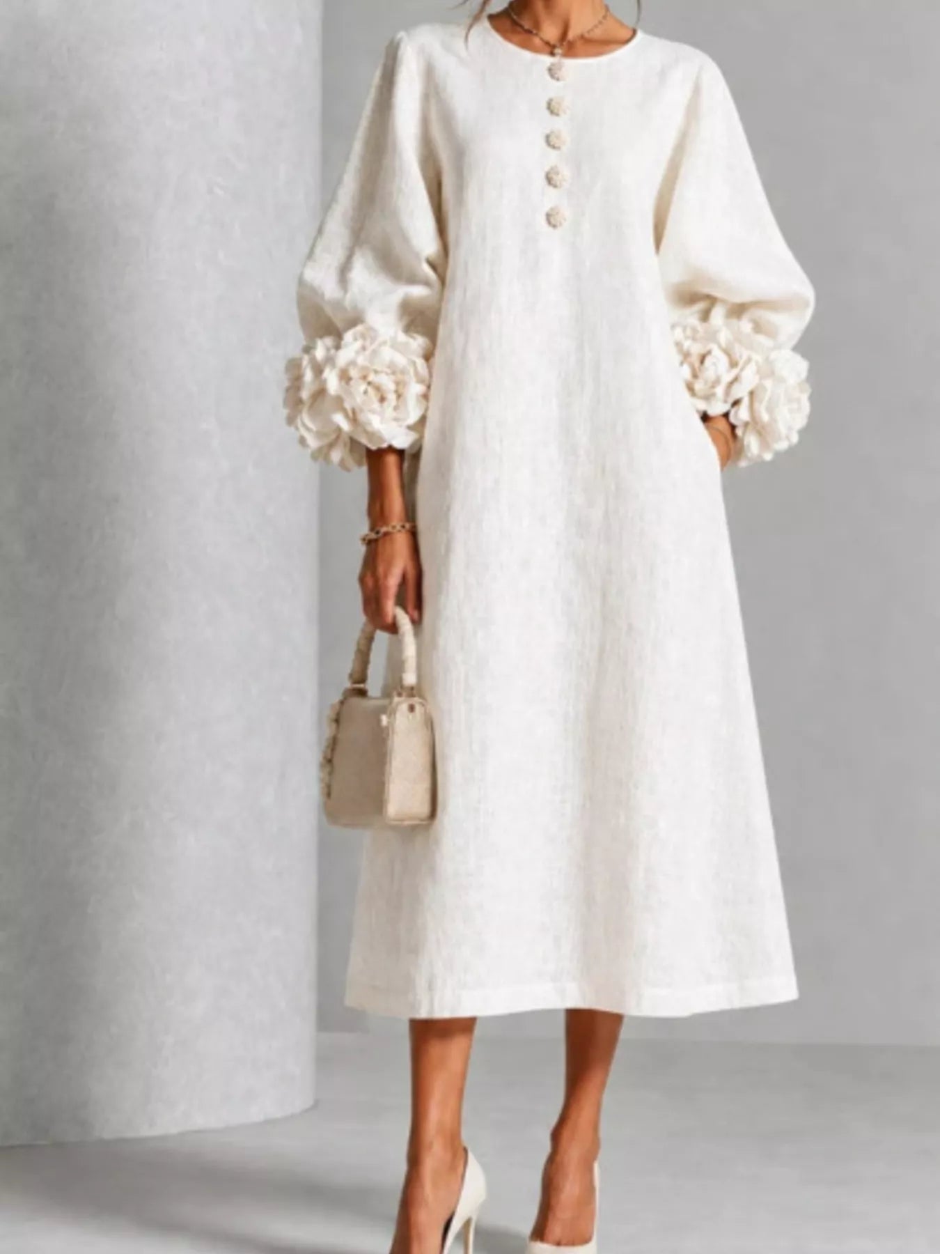 White round neck midi dress with balloon sleeves, floral cuffs and small floral buttons, front view