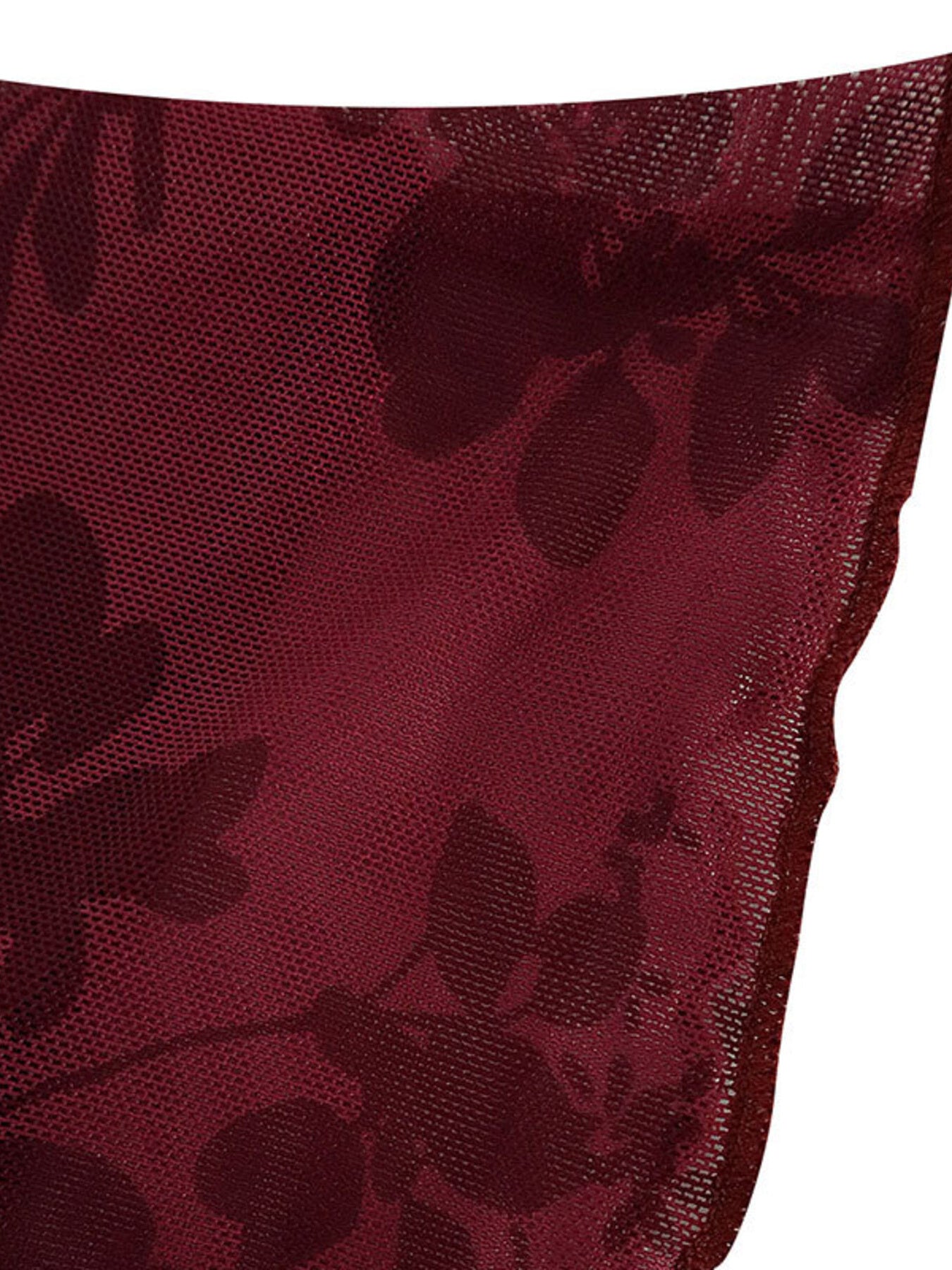 Burgundy floral mesh fabric close up showing sheer texture and scalloped edge detail