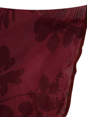 Burgundy floral mesh fabric close up showing sheer texture and scalloped edge detail