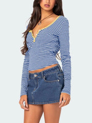 Three quarter front view of royal blue and white striped long sleeve t shirt with pale yellow button placket