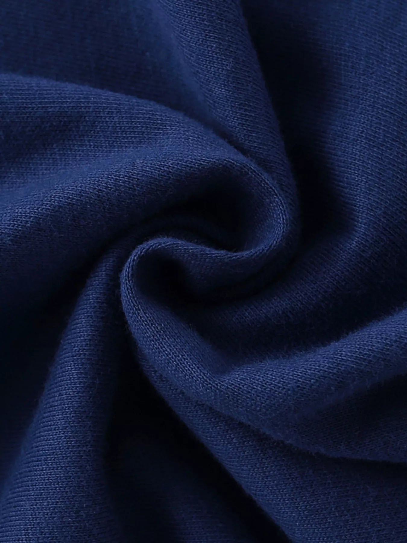 Close-up of soft navy cotton fabric texture with gentle folds