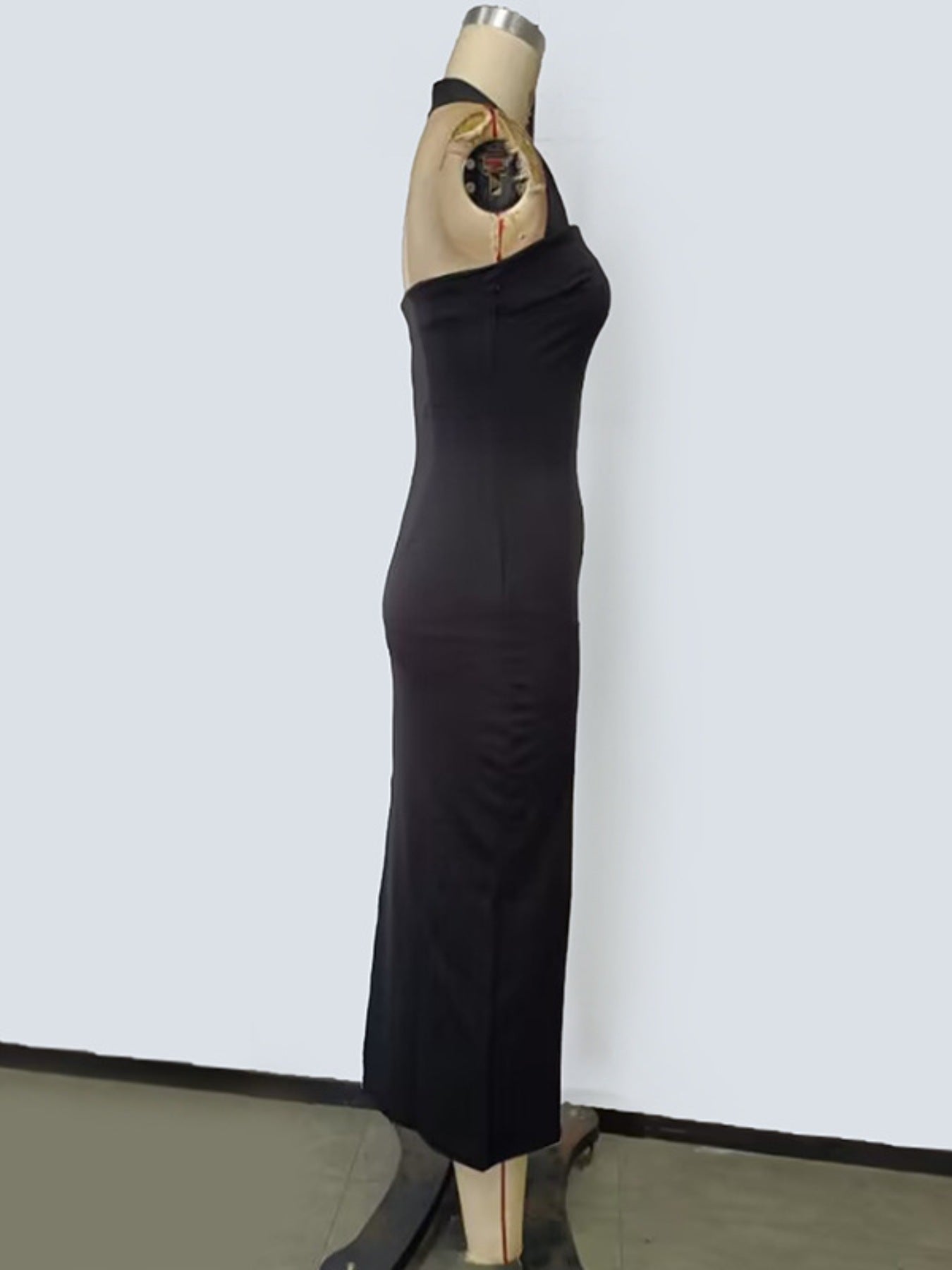 Black halter neck bodycon midi dress displayed on mannequin side view
