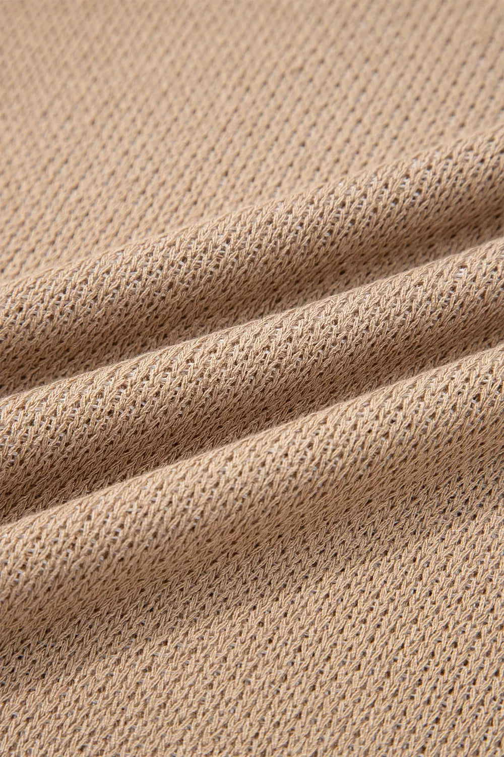 Close-up detail of mocha knit fabric with a fine open texture