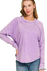 Lavender washed round-neck long-sleeve top with raglan seams and a relaxed fit on a model