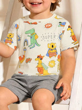 Front view of a beige children's tee with superhero animal prints, worn on a model