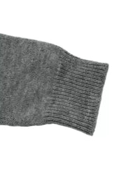 Close-up of a ribbed gray sweater cuff on a long knit sleeve