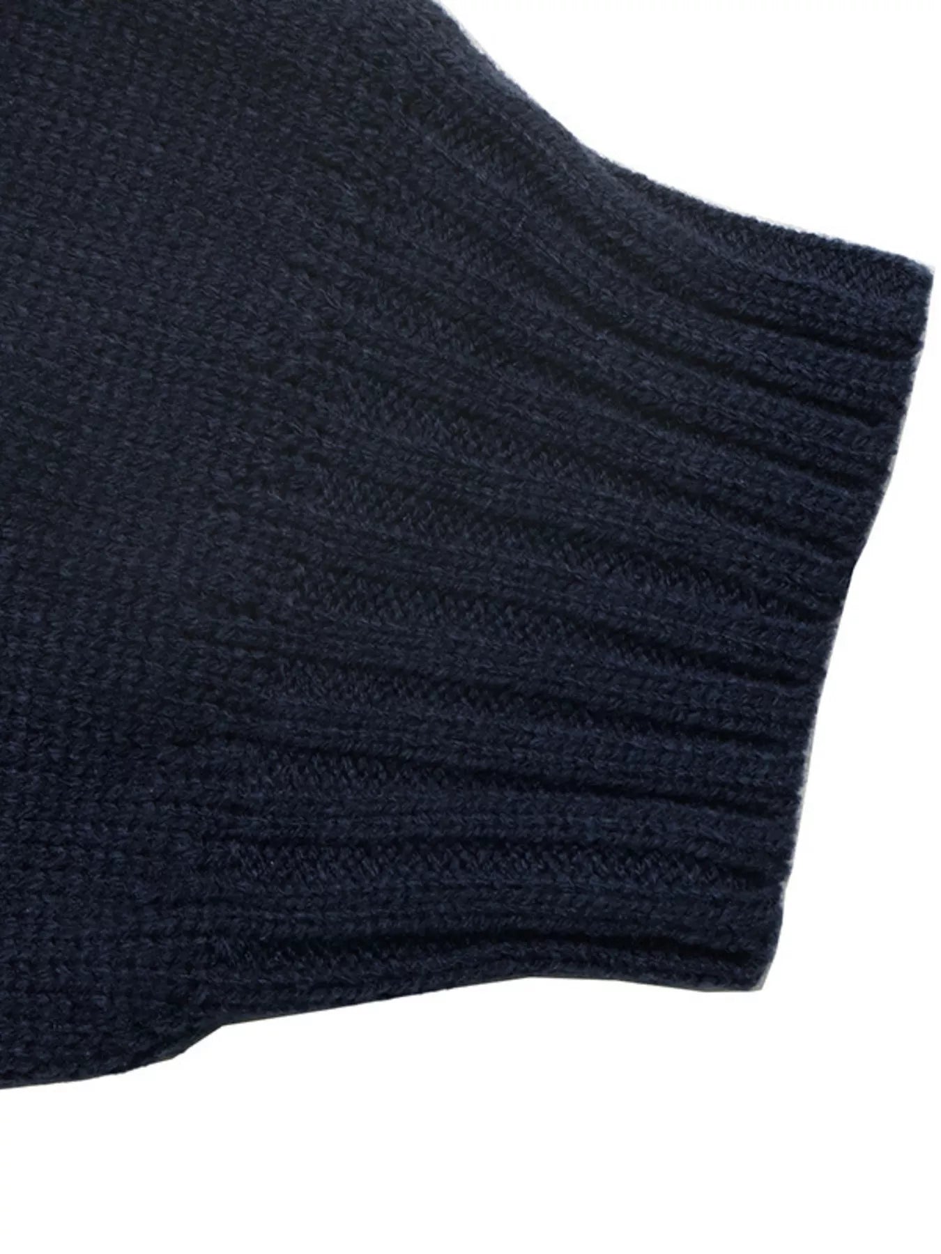 Close up of a navy ribbed sweater cuff with fine knit texture