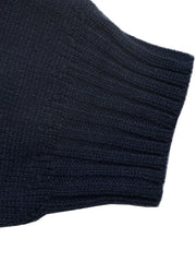 Close up of a navy ribbed sweater cuff with fine knit texture