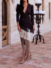 Full length front view of a black fringed maxi dress with cream and taupe fringe tiers