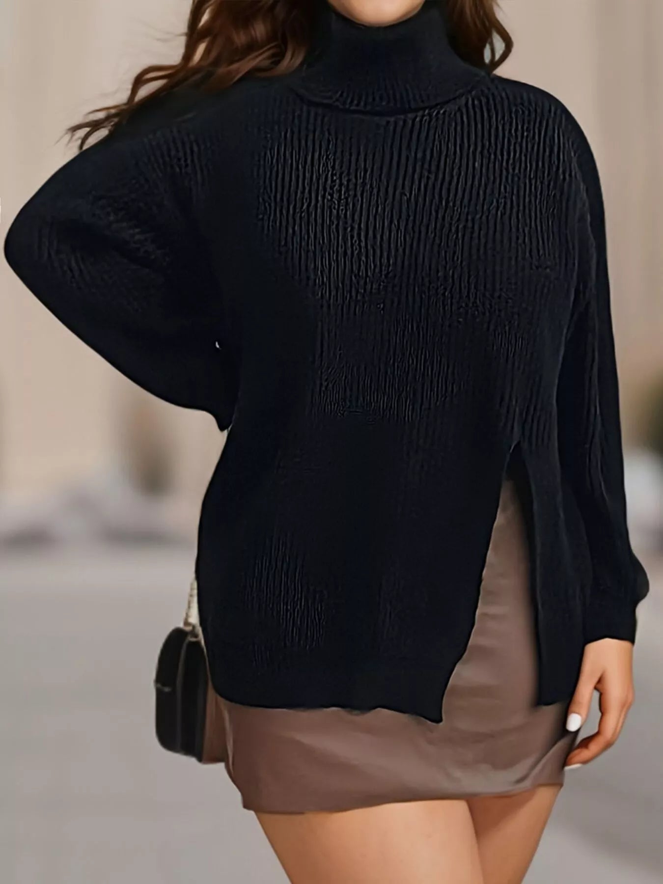Black ribbed turtleneck sweater with side slit worn on model