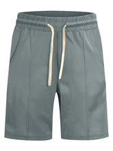 Men's sage casual shorts with a drawstring waist and pockets.