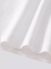 Close up of the white bottom hem showing fine stitching and overlock detail
