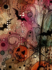 Close up view of the multicolor openwork knit cover up with a jack o lantern, bats, and ghost.