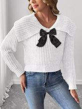 White waffle knit sweater with black bow and folded wide collar