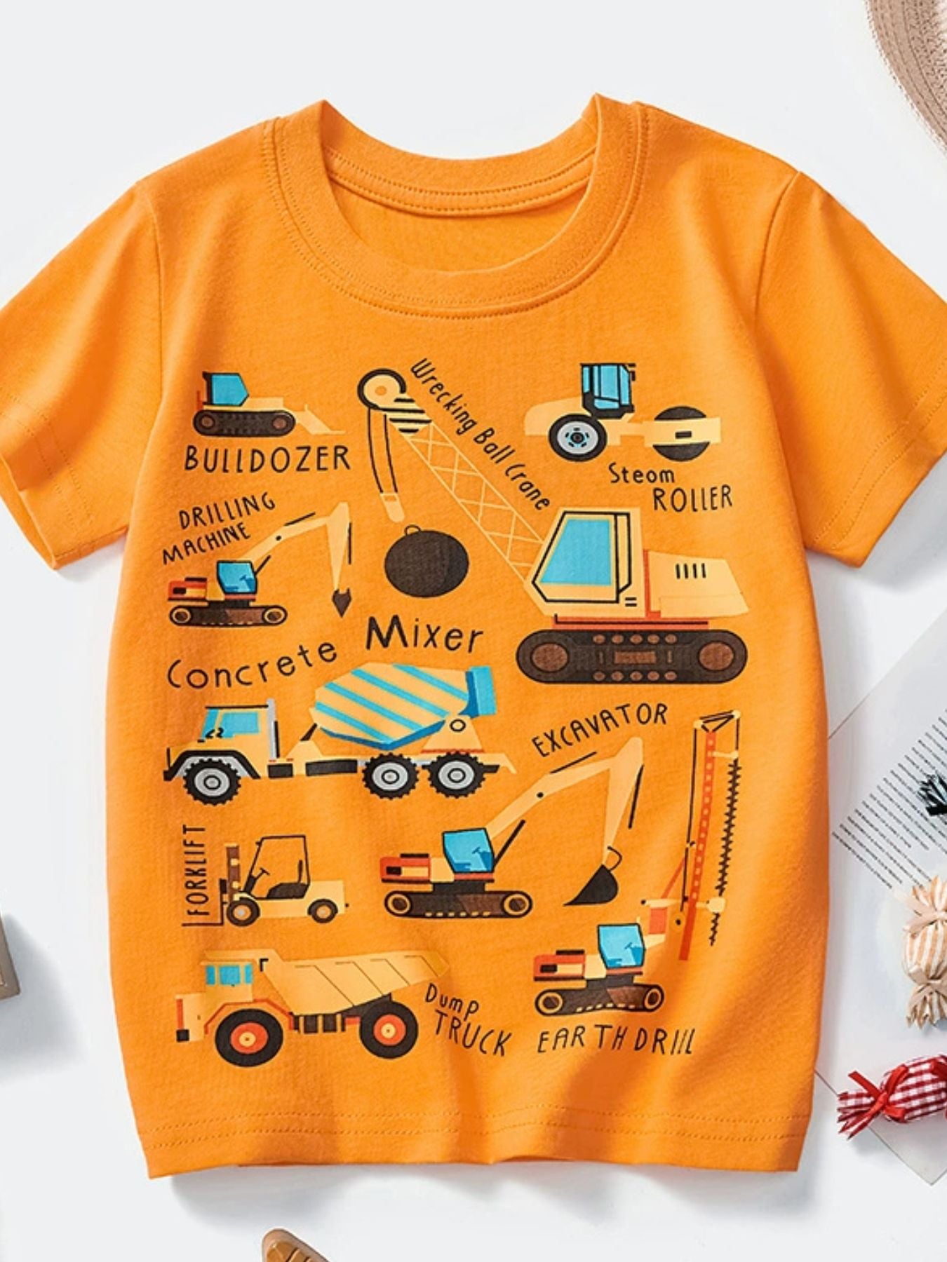 Tangerine children's crew neck short sleeve T-shirt with labeled construction vehicle graphics, laid flat in front view