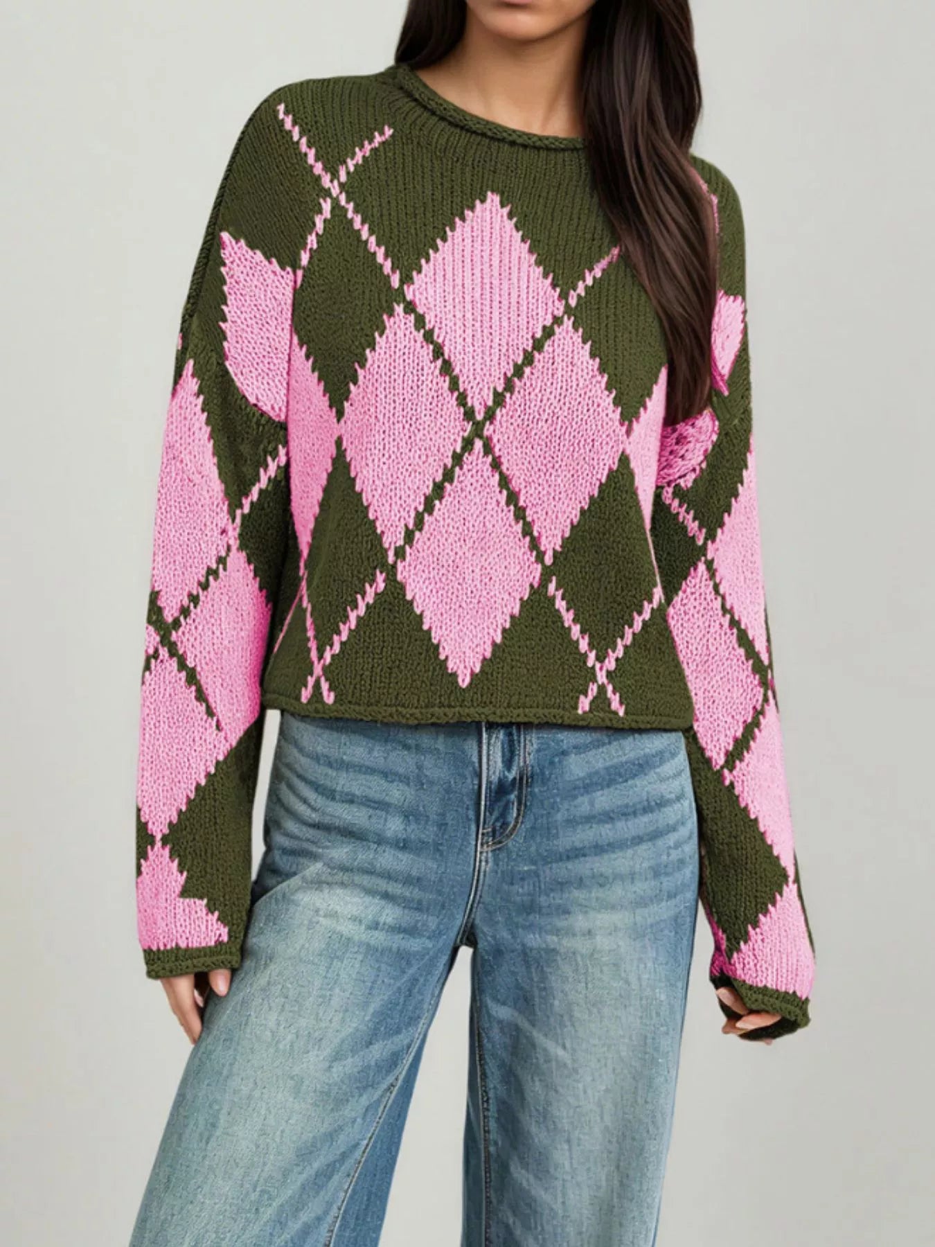 On-model front view of the olive and pink argyle sweater showing the long dropped sleeves
