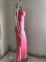 Side view of a burnt coral spaghetti strap bodycon maxi dress on a clear mannequin with a flared hem