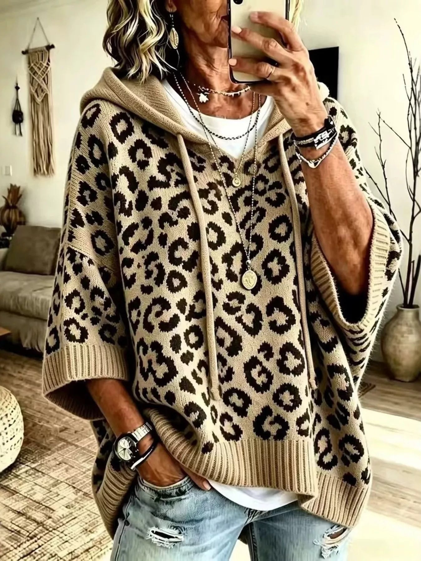 Beige leopard print oversized hooded knit sweater with wide sleeves, front view on model