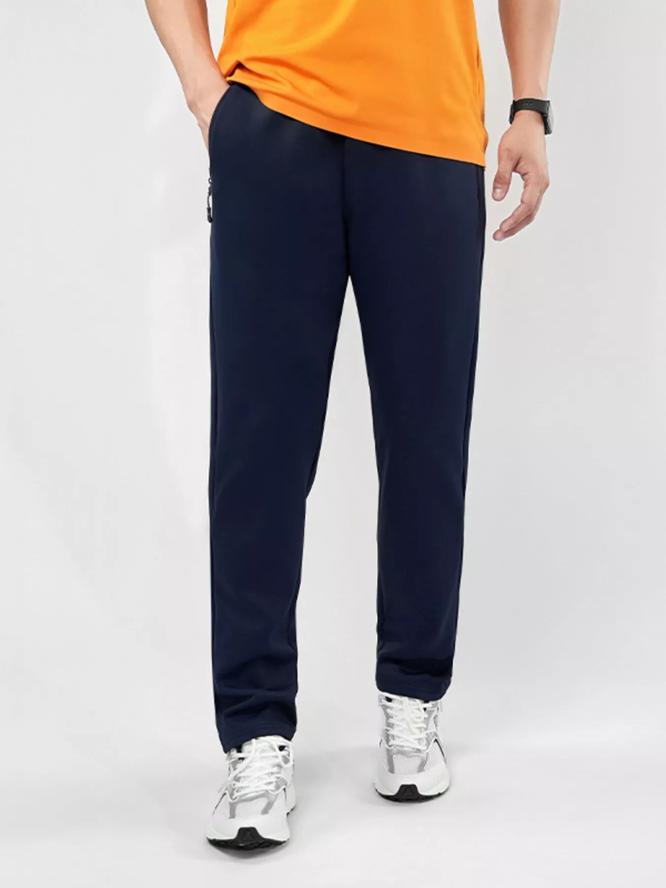 Men's plus-size stretch pants in black with an elastic waist and zipper pockets.
