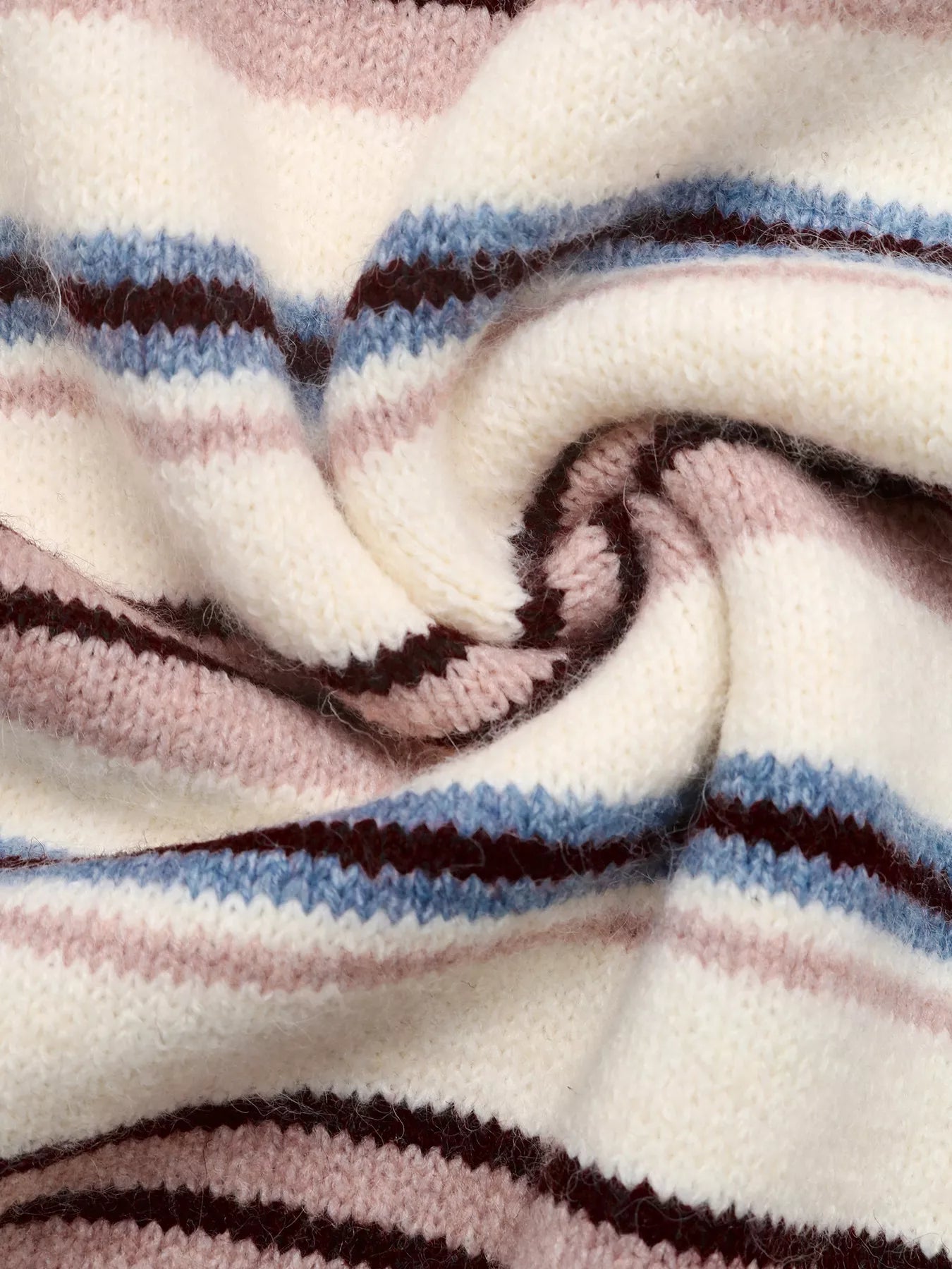 Close-up of soft striped knit fabric in cream, pink, blue, and burgundy
