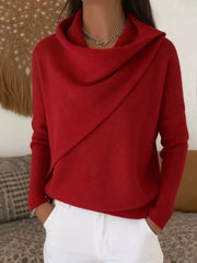 On-model front view of a red cowl neck sweater with a draped asymmetric collar and long sleeves