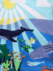 Close-up detail of the ocean print showing whales, turtles, fish, and a seal on blue fabric