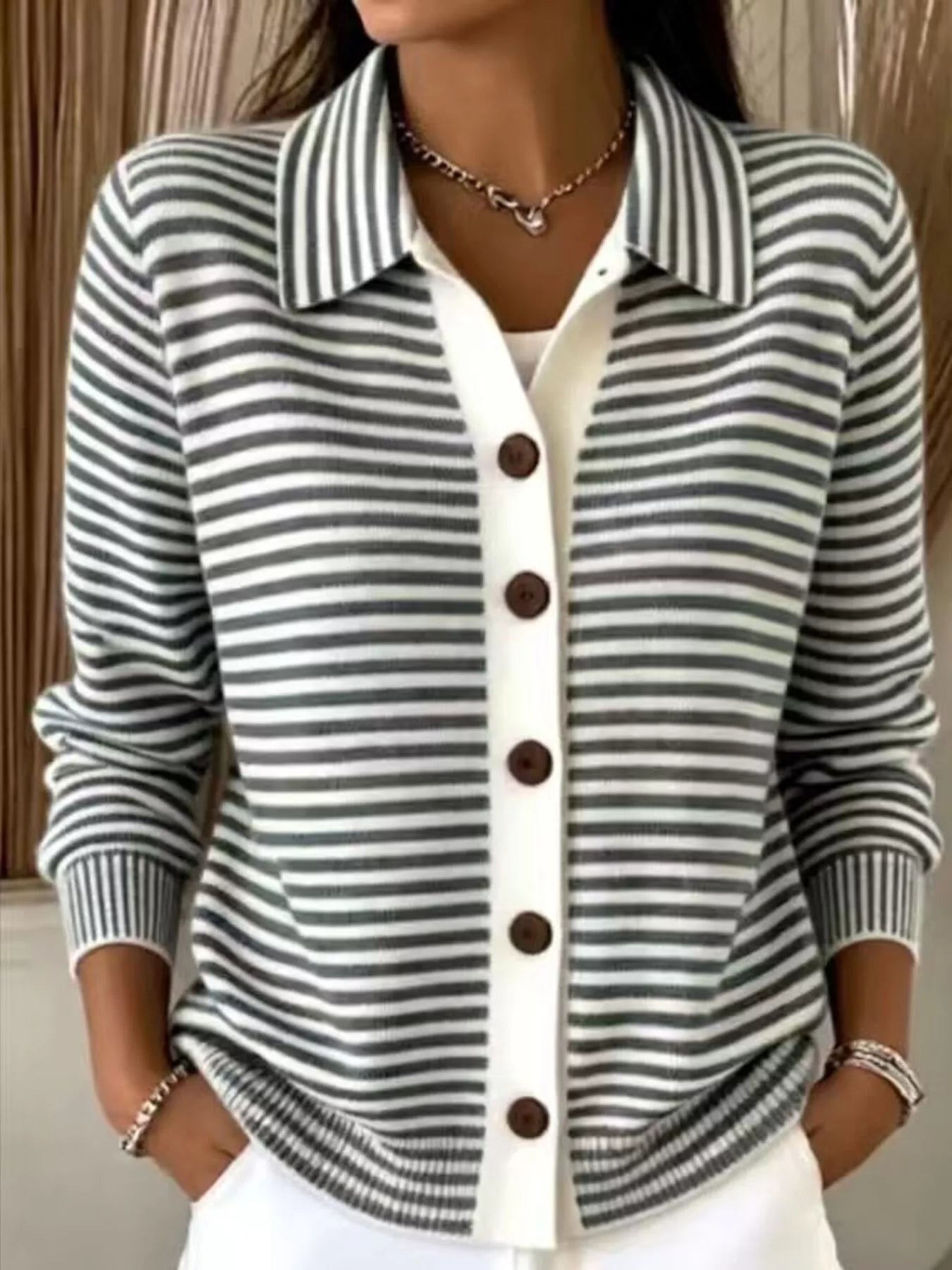 On-model front view of black and white striped collared cardigan with brown buttons