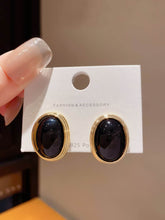 Black and Gold Toned Oval Clip On Earrings Black