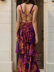 Back view of a deep purple floral maxi dress showing crisscross tie straps and layered ruffles