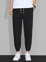 Men's black casual joggers with a drawstring waist, available in plus sizes.