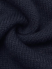 Close up of soft navy knit fabric in a swirled fold showing fine texture