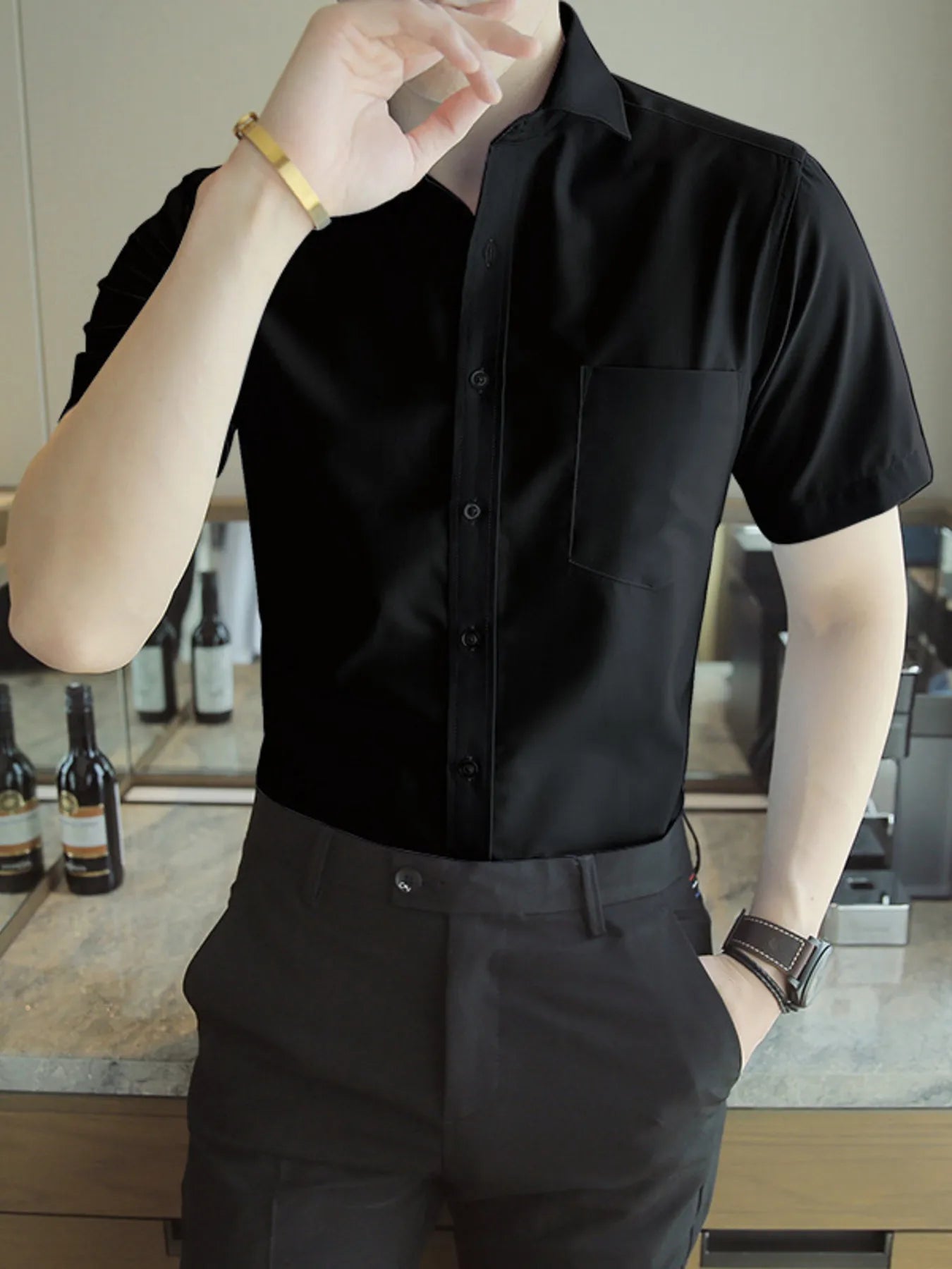 Men's solid-color slim-fit short-sleeve shirt with button detailing in a cotton-spandex blend.