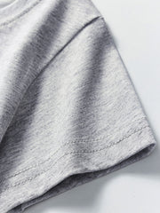 Close-up of the short sleeve hem stitching on a light gray children's crew neck T-shirt