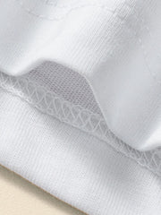Close view of the white children's tee seam showing fine stitching and soft knit fabric texture