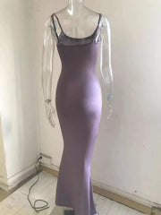 Back view of a mauve spaghetti strap bodycon maxi dress on a clear mannequin showing thin shoulder straps