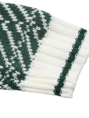 Close-up of the white ribbed cuff with a green stripe on the geometric sweater