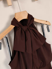 Brown halter mini dress on hanger, close view of knotted back neckline detail