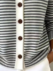 Close-up of the lower front and ribbed hem of a black and white striped knit cardigan