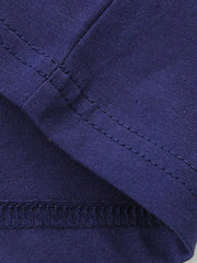 Close up of dark navy stitching at a sleeve and hem seam on a children's tee