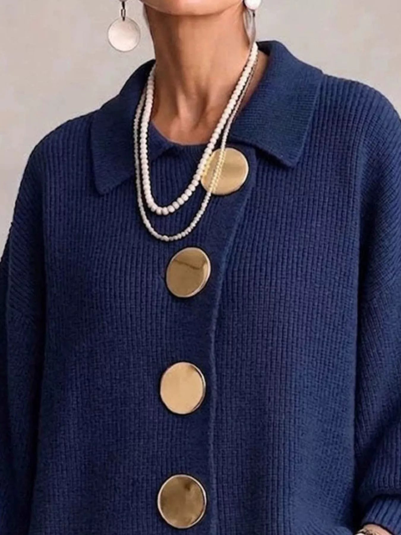 Close up of the navy cardigan collar and large gold front buttons
